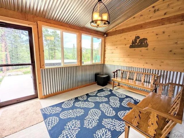 a view of a balcony with wooden floor and outdoor seating
