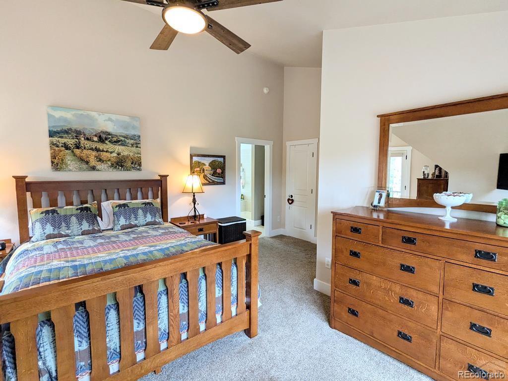 10 Robert Road Rye, CO 81069 - Photo 23 of 50 a bedroom with a bed a chandelier and a dresser