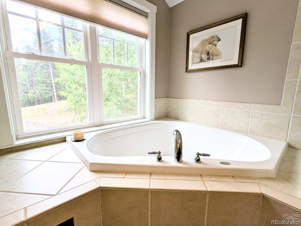 10 Robert Road Rye, CO 81069 - Photo 28 of 50 a white bath tub sitting next to a window