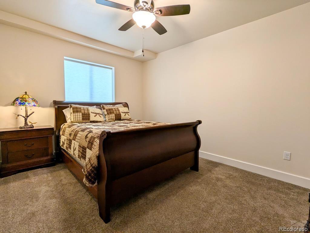 10 Robert Road Rye, CO 81069 - Photo 37 of 50 a bedroom with a bed and a chandelier