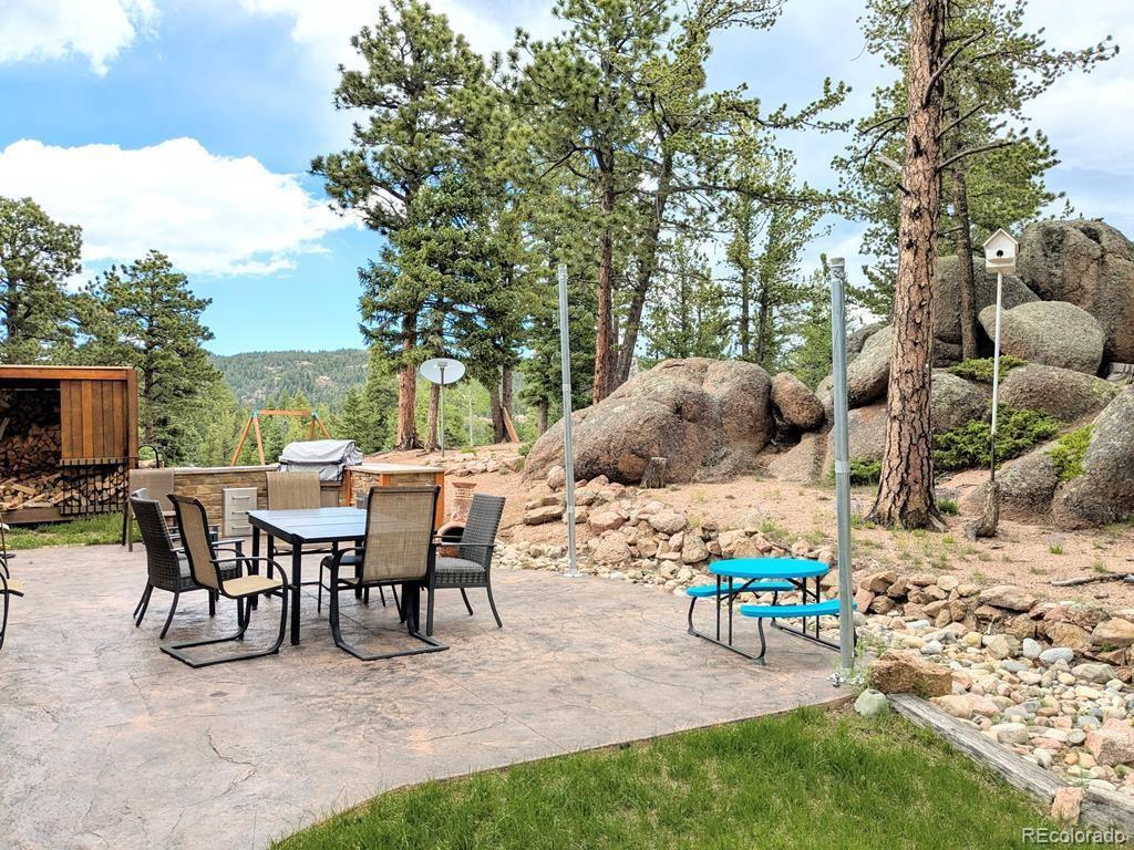 10 Robert Road Rye, CO 81069 - Photo 40 of 50 a view of a patio with table and chairs potted plants and large tree