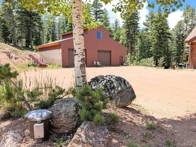 a kitchen with stainless steel appliances granite countertop a stove a refrigerator and a dining table