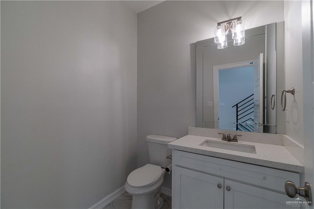 5404 North Crown Point Pharr, TX 78577 - Photo 18 of 24 a bathroom with a toilet a sink and mirror