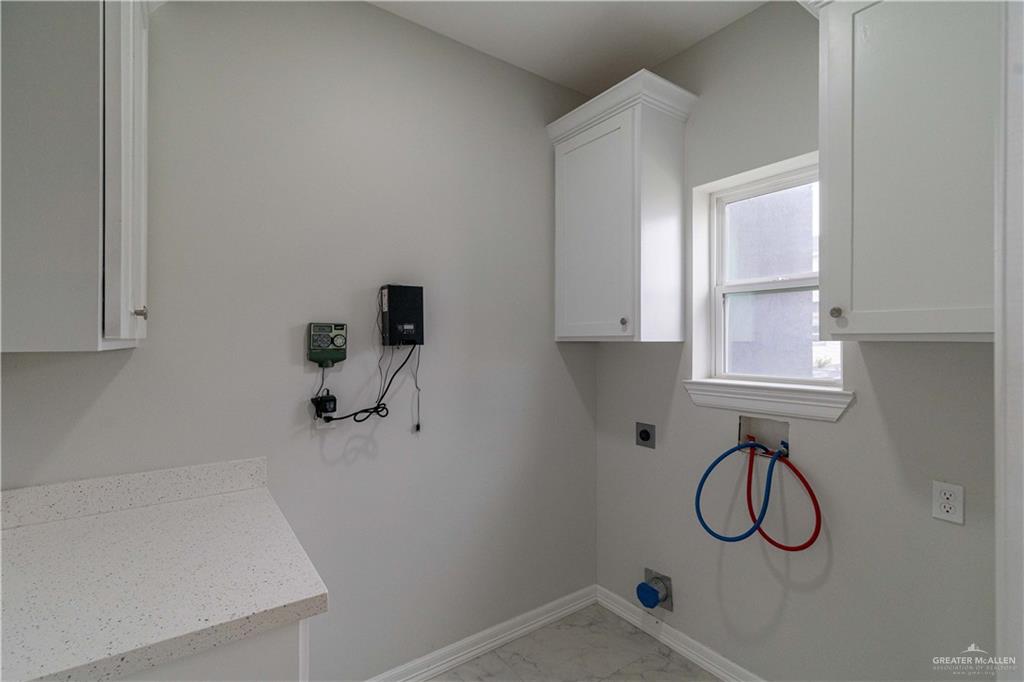 5404 North Crown Point Pharr, TX 78577 - Photo 19 of 24 a bathroom with a granite countertop sink and a window