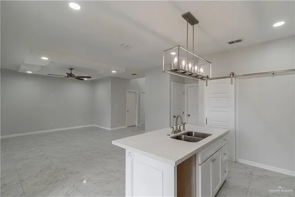 a bathroom with a sink a light fixture and a mirror