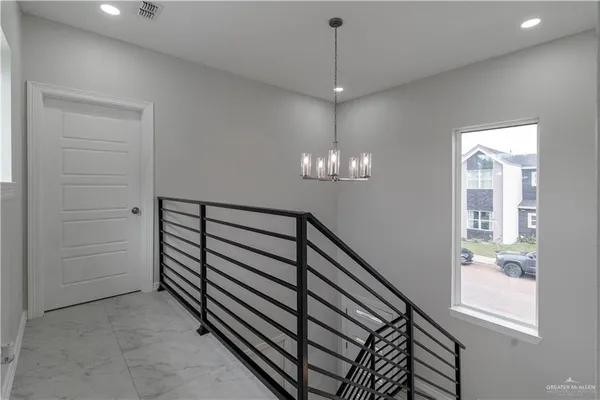 a view of a hallway with windows