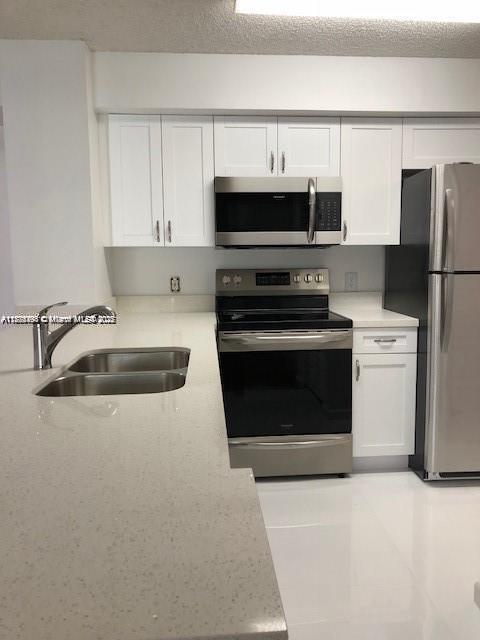 650 South Park Road, Unit 285 Hollywood, FL 33021 - Photo 3 of 13 a kitchen with cabinets and steel stainless steel appliances