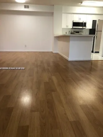 a kitchen with kitchen island a sink counter top space and appliances