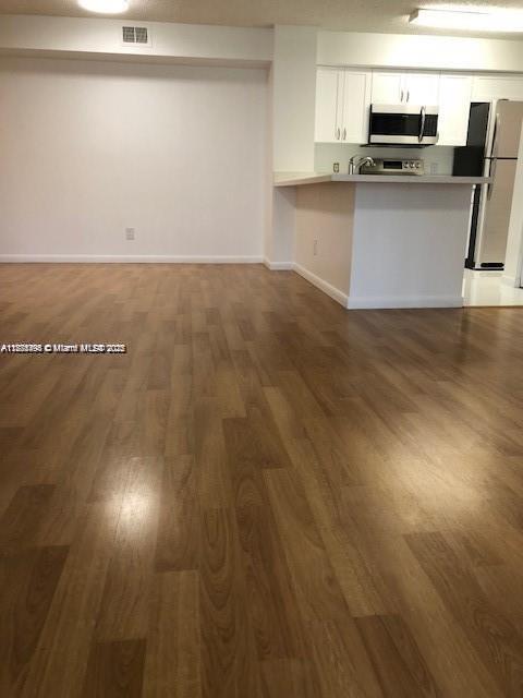 650 South Park Road, Unit 285 Hollywood, FL 33021 - Photo 5 of 13 a kitchen with kitchen island a sink counter top space and appliances