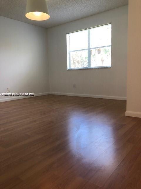 650 South Park Road, Unit 285 Hollywood, FL 33021 - Photo 7 of 13 an empty room with wooden floor and windows