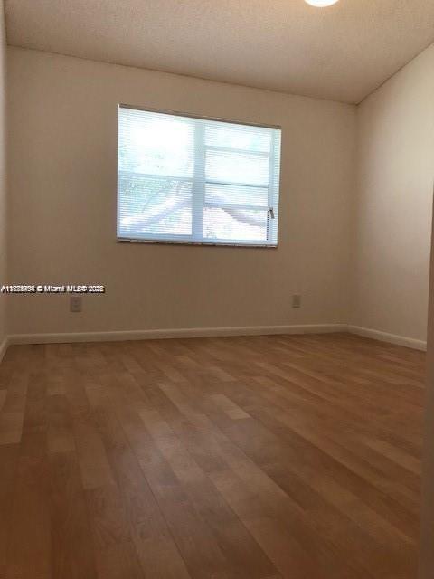 650 South Park Road, Unit 285 Hollywood, FL 33021 - Photo 9 of 13 an empty room with wooden floor and windows