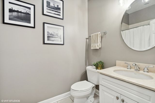 a bathroom with a granite countertop toilet a sink and a mirror