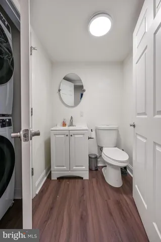 a bathroom with a toilet sink a mirror and vanity
