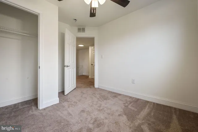 an empty room with a empty space and a ceiling fan