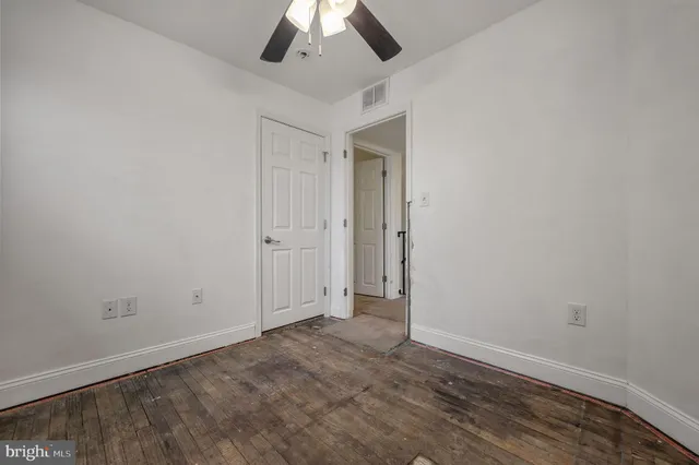 an empty room with a empty space and a ceiling fan