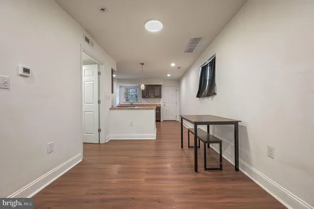 a view of kitchen with cabinets and wooden floor
