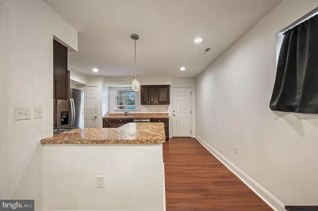 a kitchen with stainless steel appliances granite countertop a sink a stove and a refrigerator