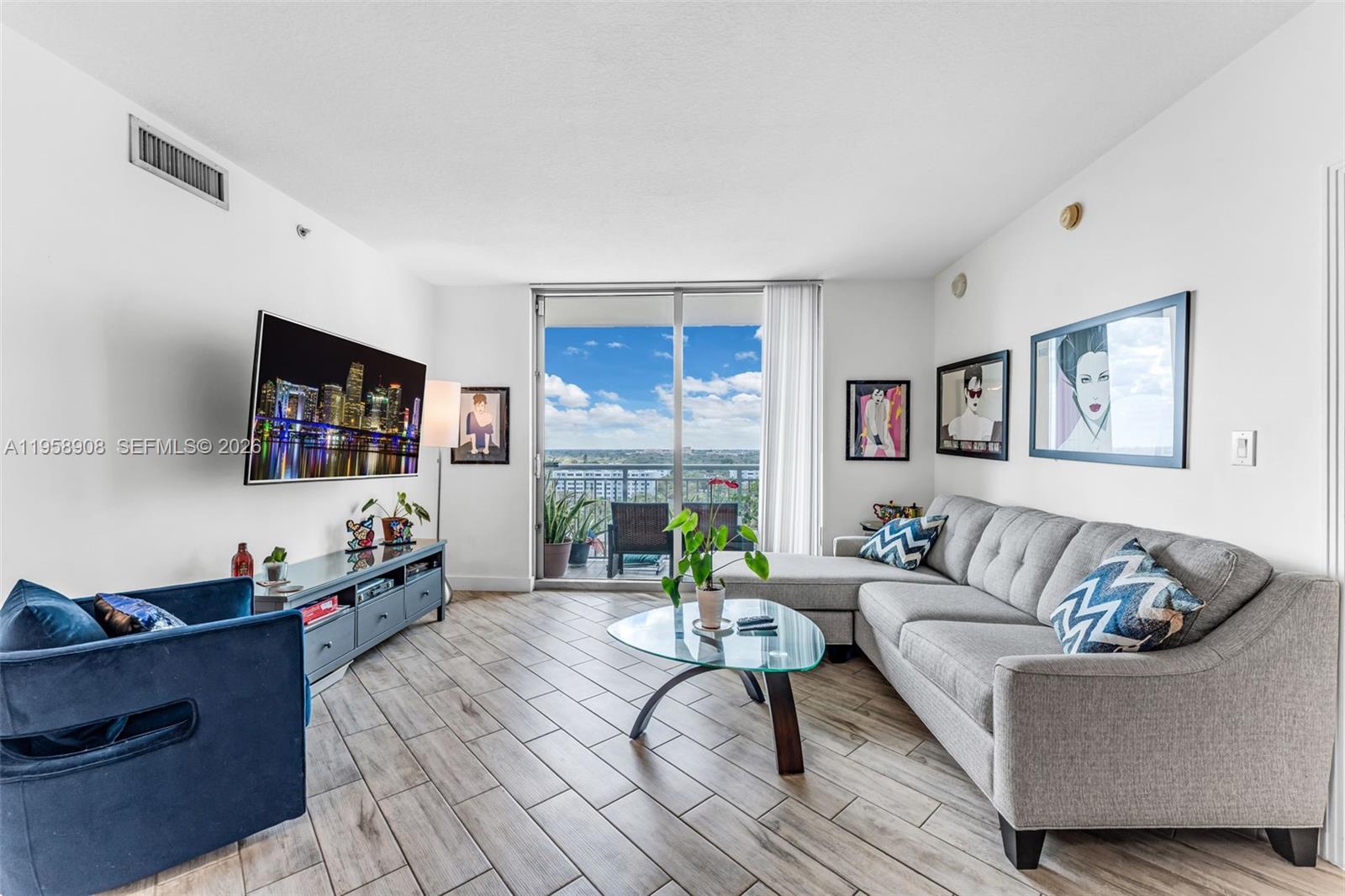 9066 Southwest 73rd Court, Unit 908 Miami, FL 33156 - Photo 11 of 46 a living room with furniture and a flat screen tv