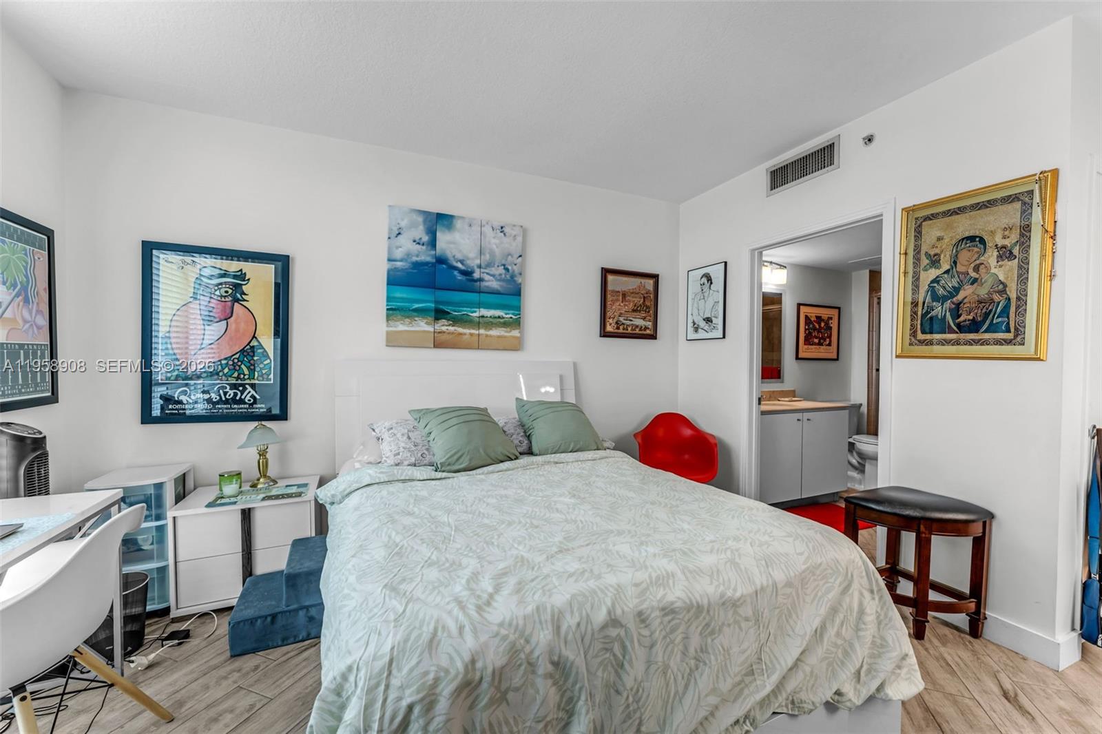 9066 Southwest 73rd Court, Unit 908 Miami, FL 33156 - Photo 13 of 46 a bedroom with a bed and wooden floor