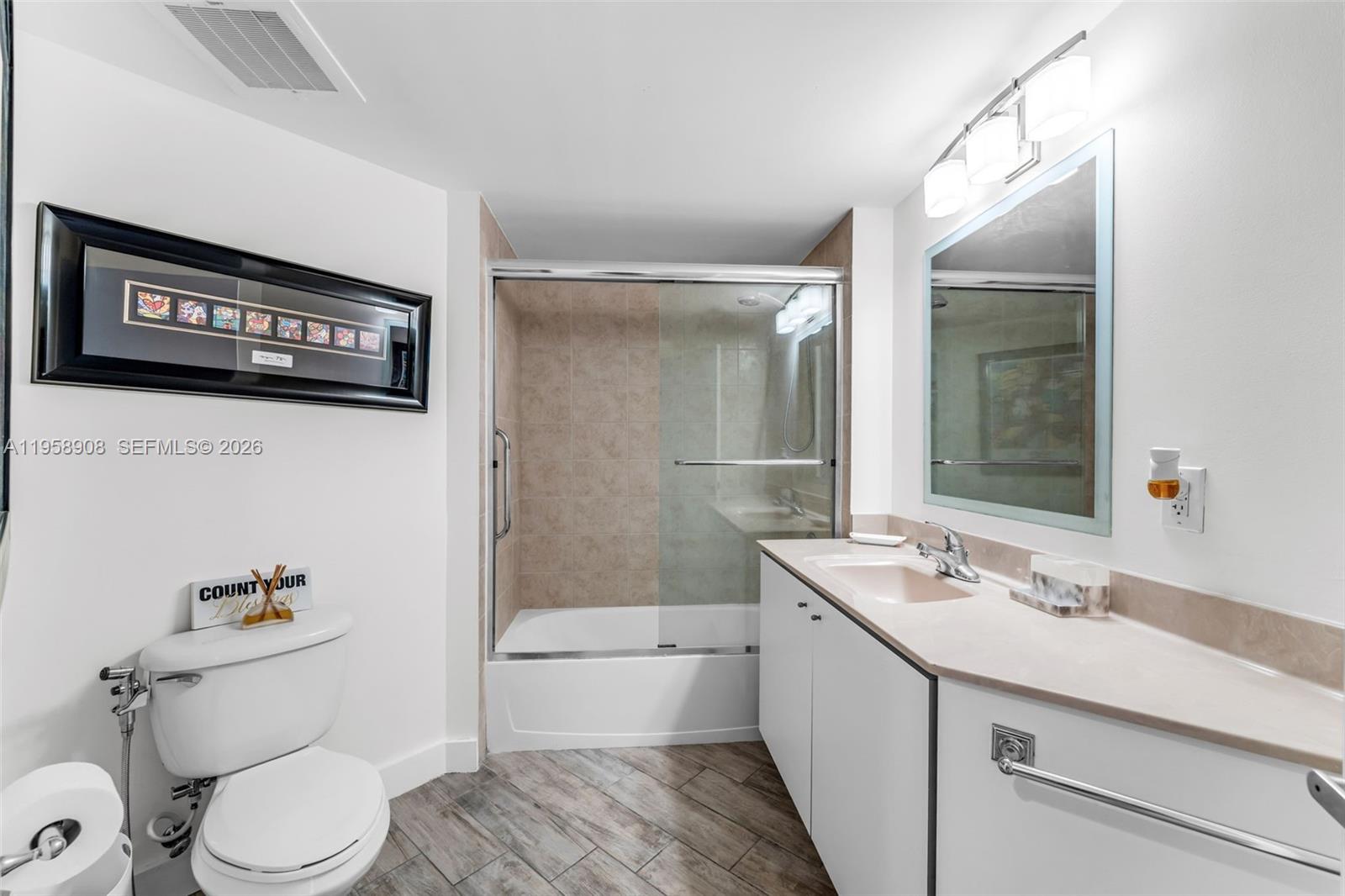 9066 Southwest 73rd Court, Unit 908 Miami, FL 33156 - Photo 16 of 46 a bathroom with a sink a toilet and shower