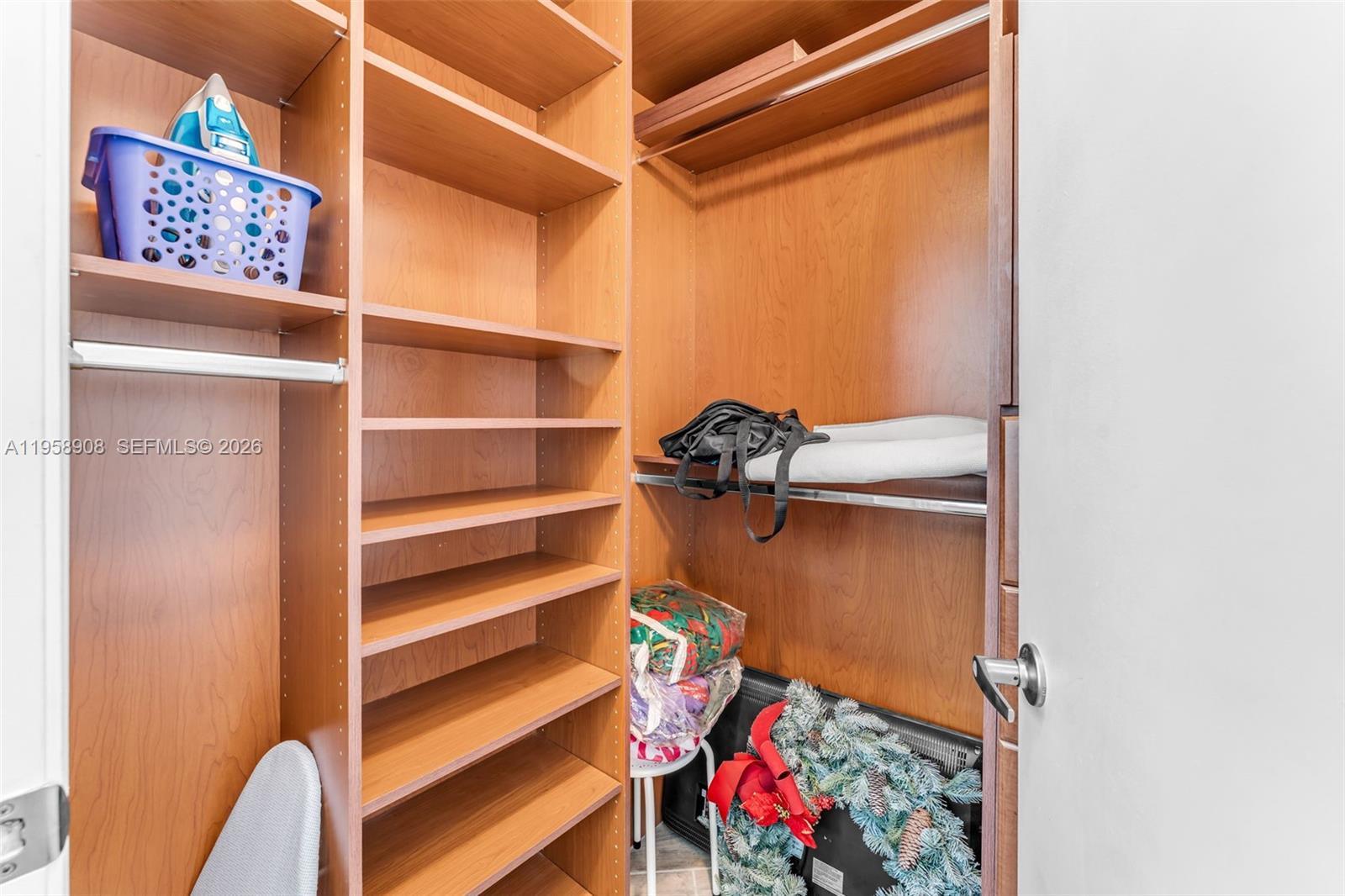 9066 Southwest 73rd Court, Unit 908 Miami, FL 33156 - Photo 17 of 46 a view of walk in closet with clothes and shoes