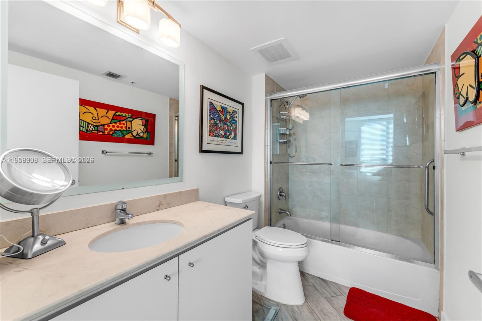 9066 Southwest 73rd Court, Unit 908 Miami, FL 33156 - Photo 20 of 46 a bathroom with a sink a toilet and shower