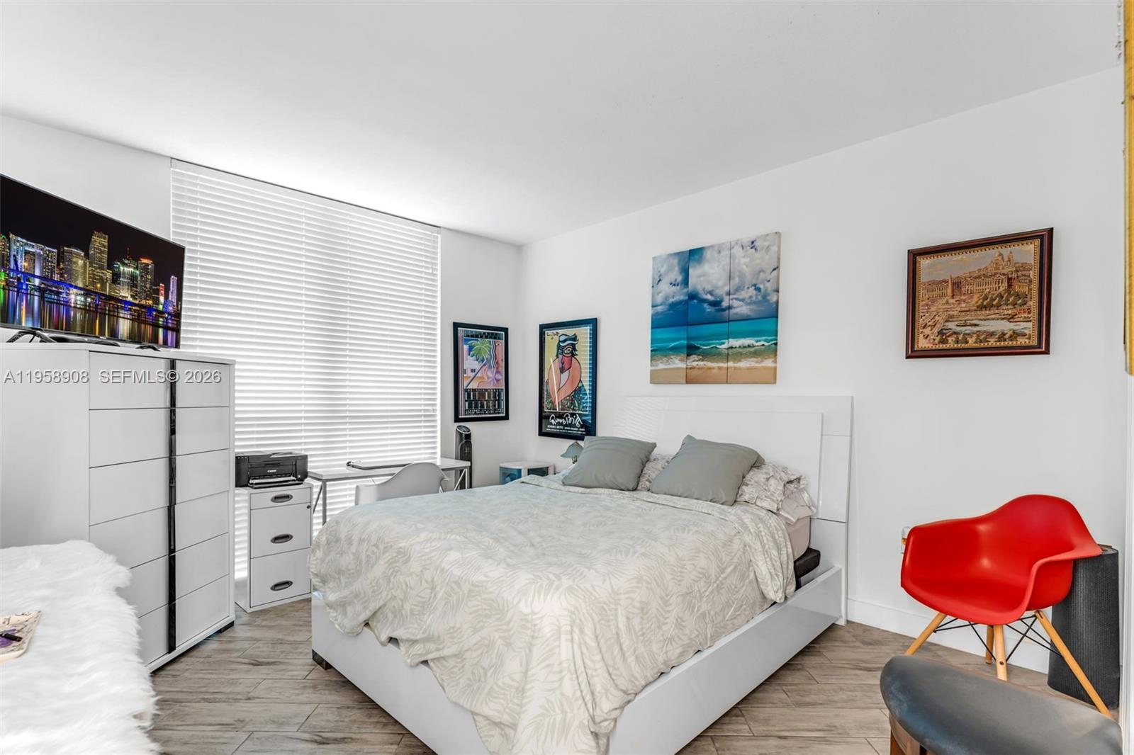 9066 Southwest 73rd Court, Unit 908 Miami, FL 33156 - Photo 21 of 46 a bedroom with a bed and a painting on the wall