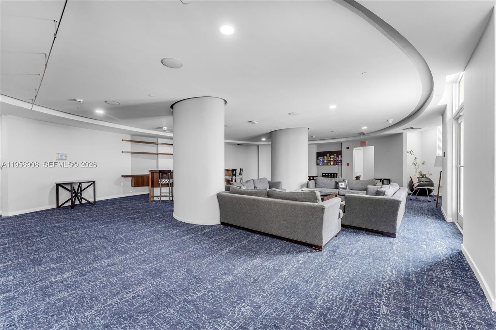 9066 Southwest 73rd Court, Unit 908 Miami, FL 33156 - Photo 30 of 46 a living room with furniture and a flat screen tv