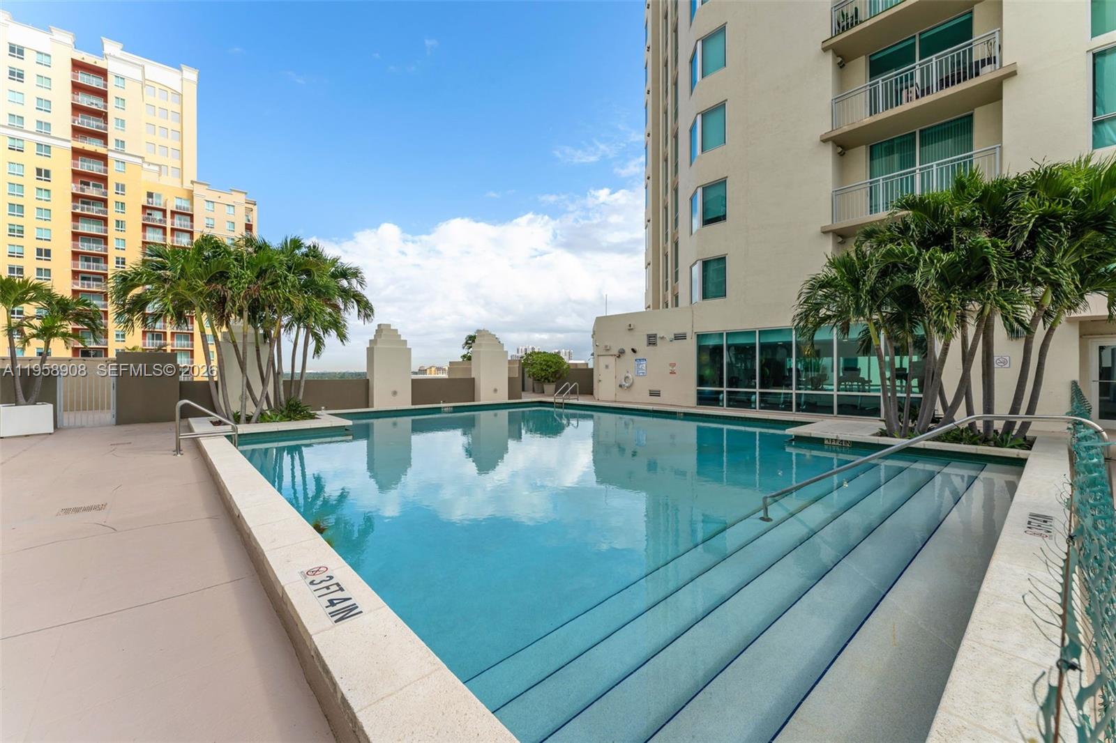 9066 Southwest 73rd Court, Unit 908 Miami, FL 33156 - Photo 32 of 46 a view of swimming pool with outdoor seating and city view