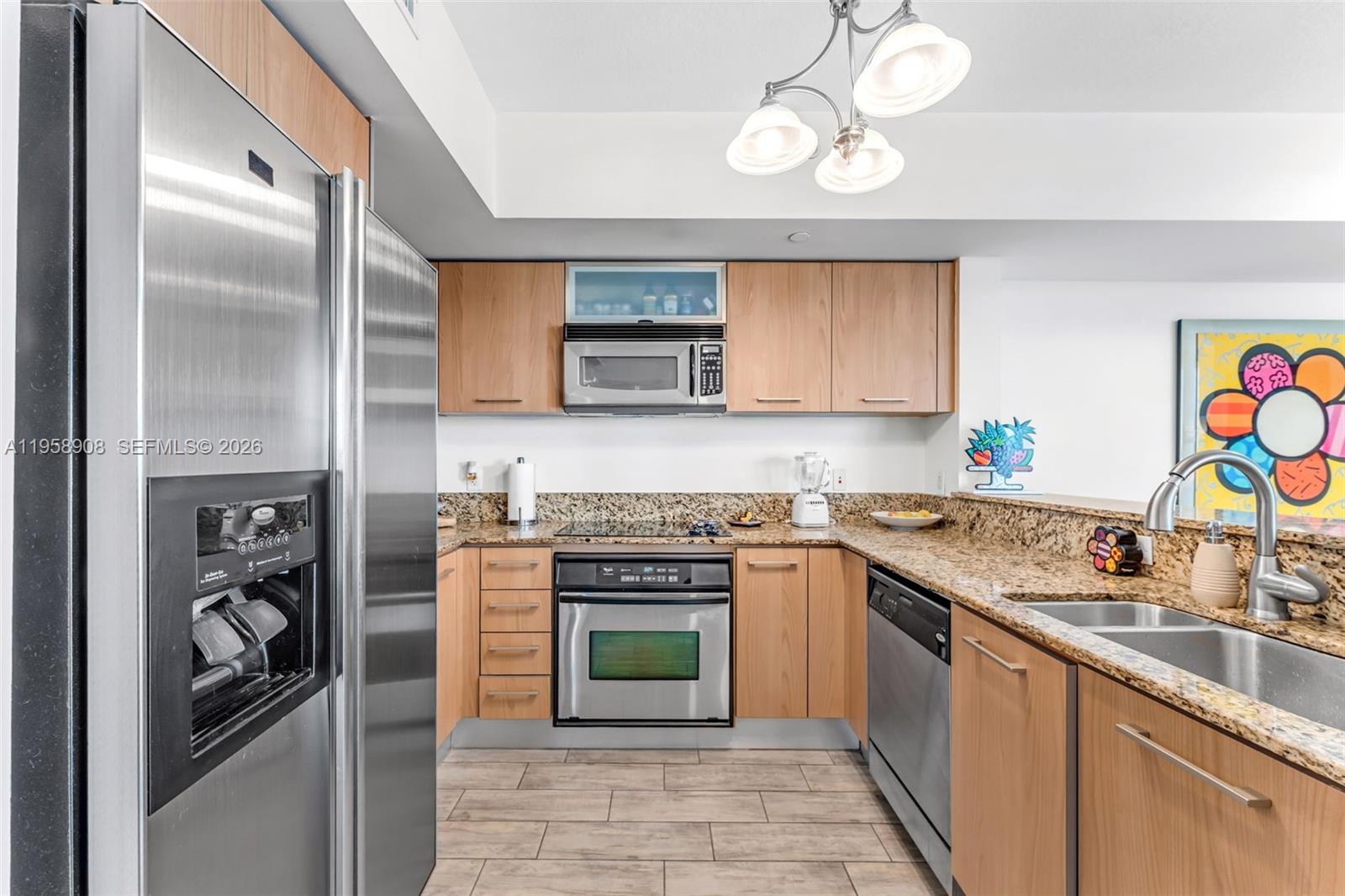 9066 Southwest 73rd Court, Unit 908 Miami, FL 33156 - Photo 4 of 46 a kitchen with stainless steel appliances granite countertop a refrigerator a stove and a sink