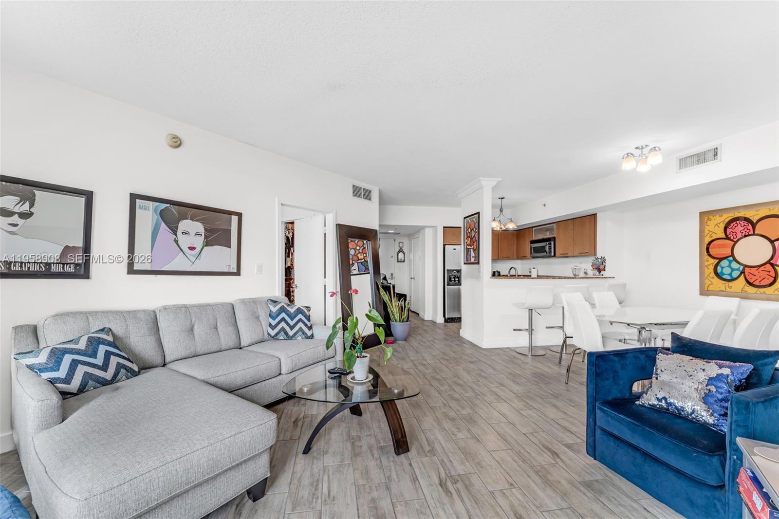 9066 Southwest 73rd Court, Unit 908 Miami, FL 33156 - Photo 8 of 46 a living room with furniture and wooden floor