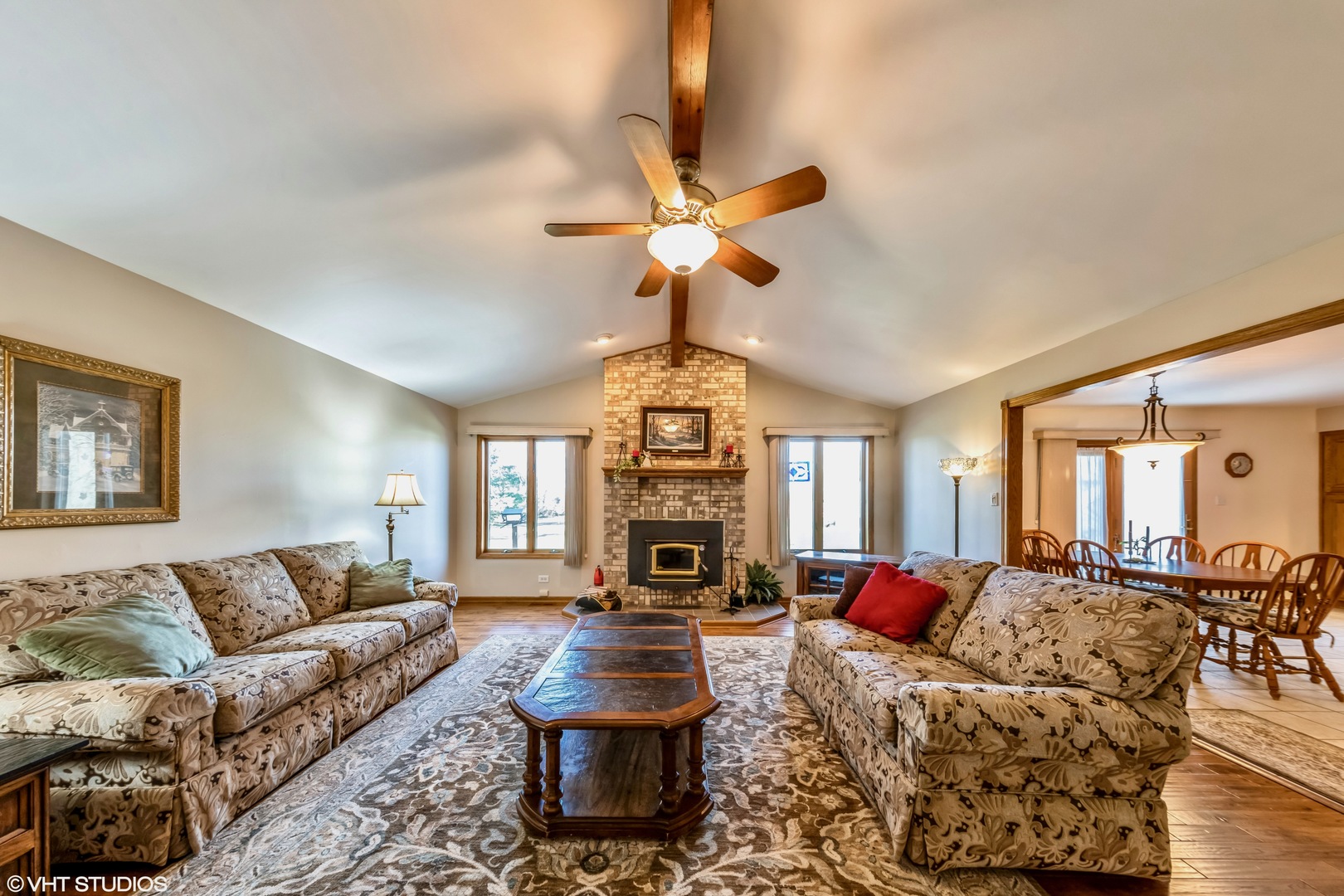29756 South State Line Road Beecher, IL 60401 - Photo 10 of 29 a living room with furniture a fireplace and a chandelier