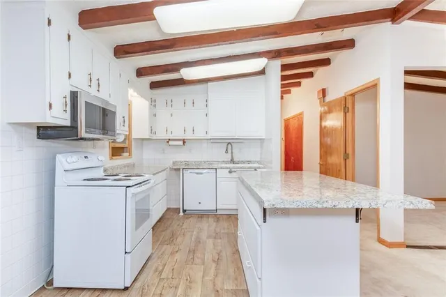 a kitchen with a sink stove and cabinets