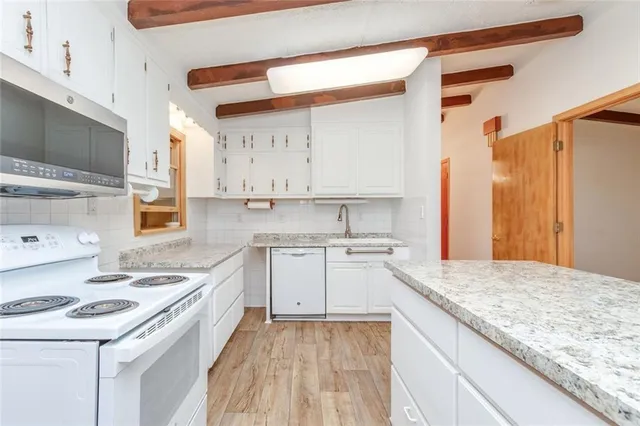 a kitchen with a sink stove and cabinets