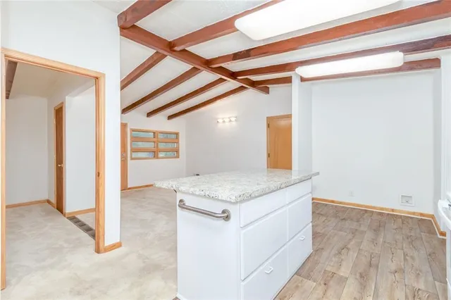 a bathroom with a granite countertop sink and mirror
