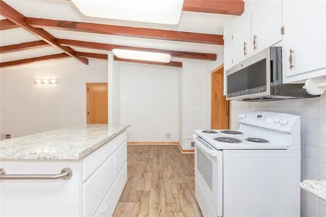 a kitchen with a stove and a microwave