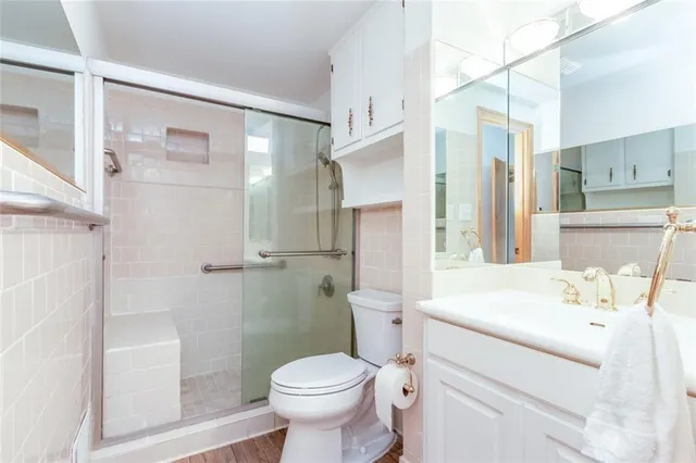 a bathroom with a sink toilet and shower