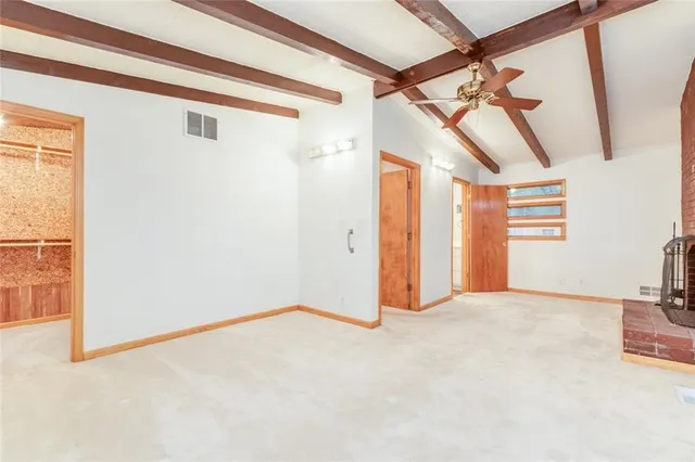 a view of empty room with fireplace