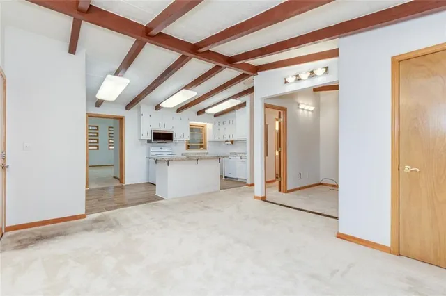 a view of a hallway with a kitchen