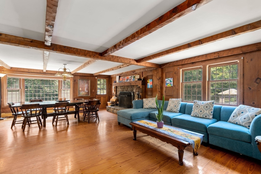 44 Mashapaug Road Holland, MA 01521 - Photo 9 of 41 a living room with furniture wooden floor and a large window