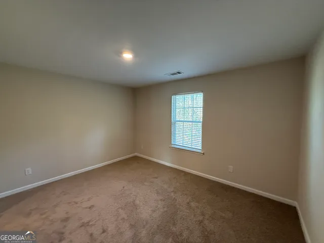 an empty room with a empty space and windows