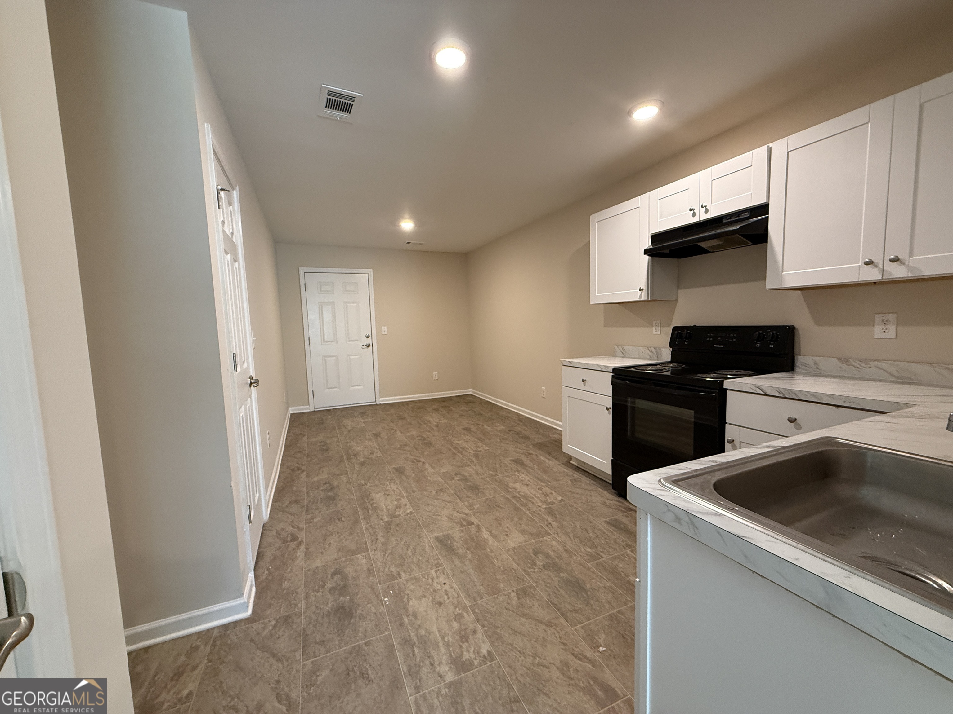 572 Elles Way Griffin, GA 30223 - Photo 5 of 23 a kitchen that has a sink and a stove top oven
