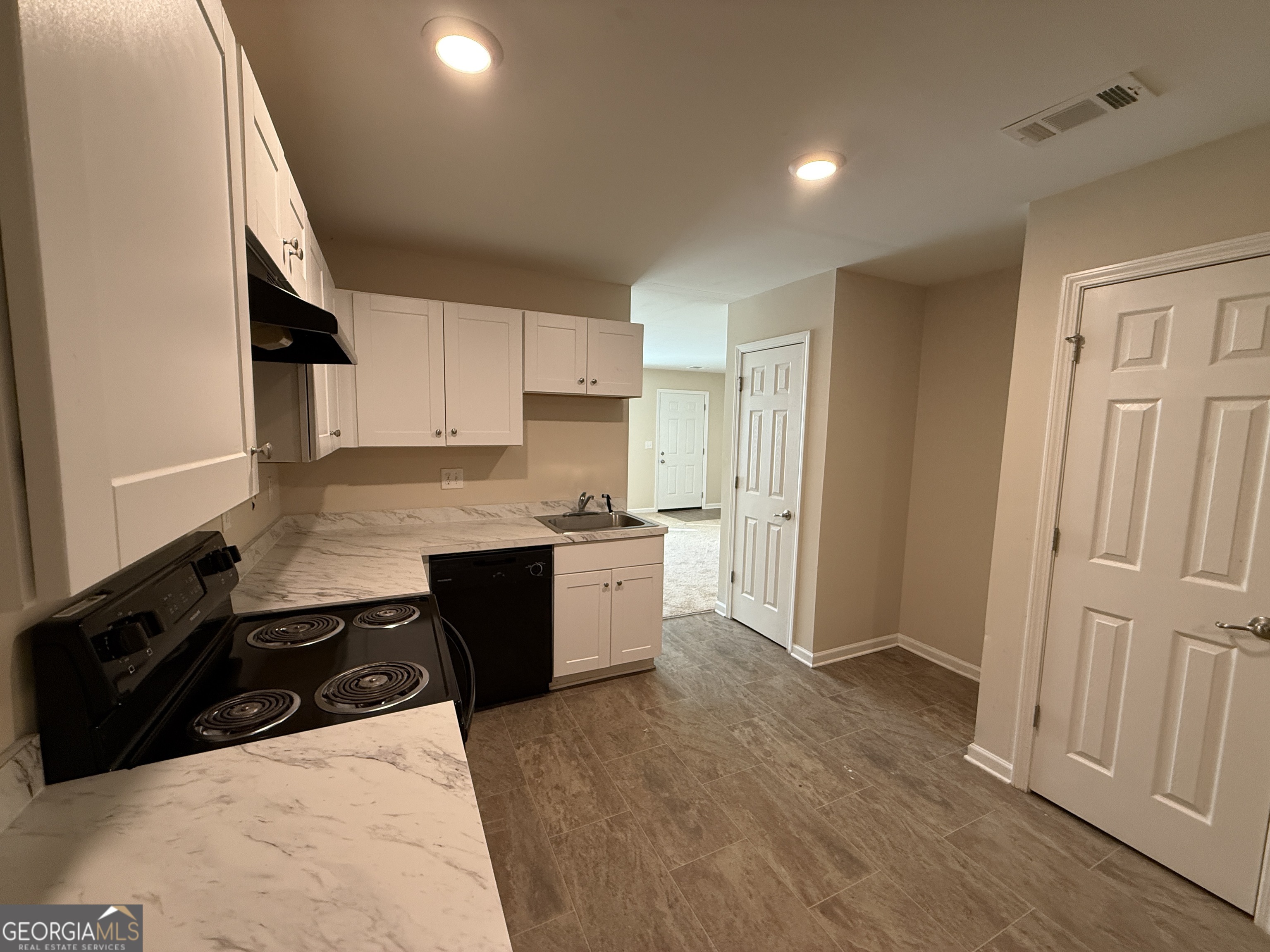 572 Elles Way Griffin, GA 30223 - Photo 8 of 23 a kitchen with granite countertop a sink a stove a refrigerator and cabinets