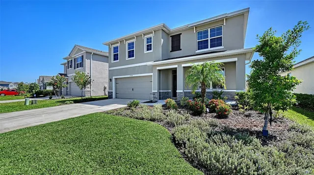 a front view of house with yard and green space