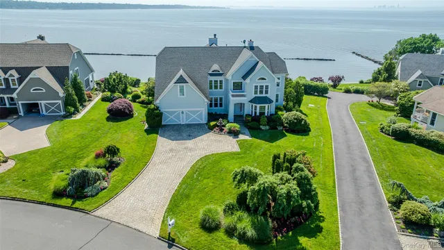 a aerial view of a house with a yard and potted plants