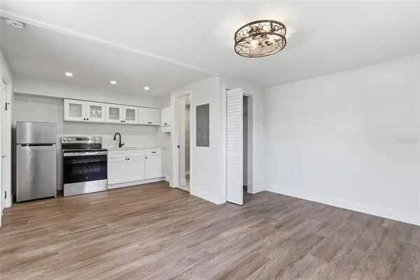 a kitchen with stainless steel appliances granite countertop a refrigerator and a stove top oven