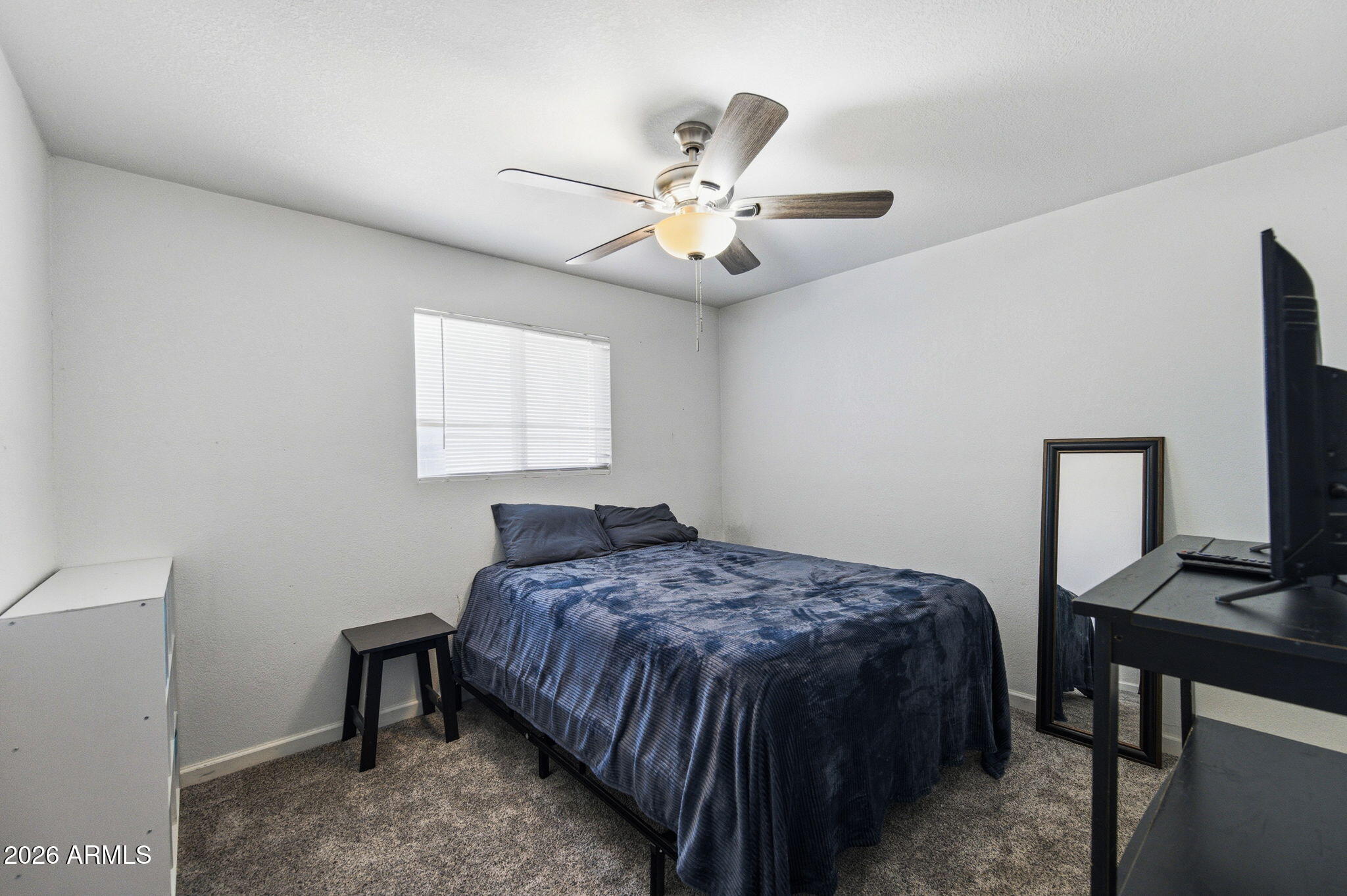 1268 East Rodeo Road Casa Grande, AZ 85122 - Photo 15 of 27 a bedroom with a bed and a chandelier