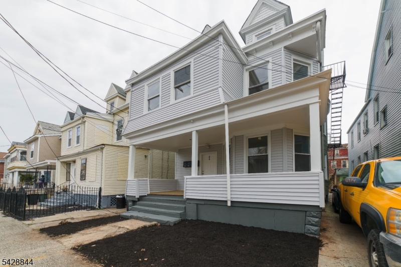 874 South 16th Street Newark, NJ 07108 - Photo 1 of 22 a view of a house with a small garden
