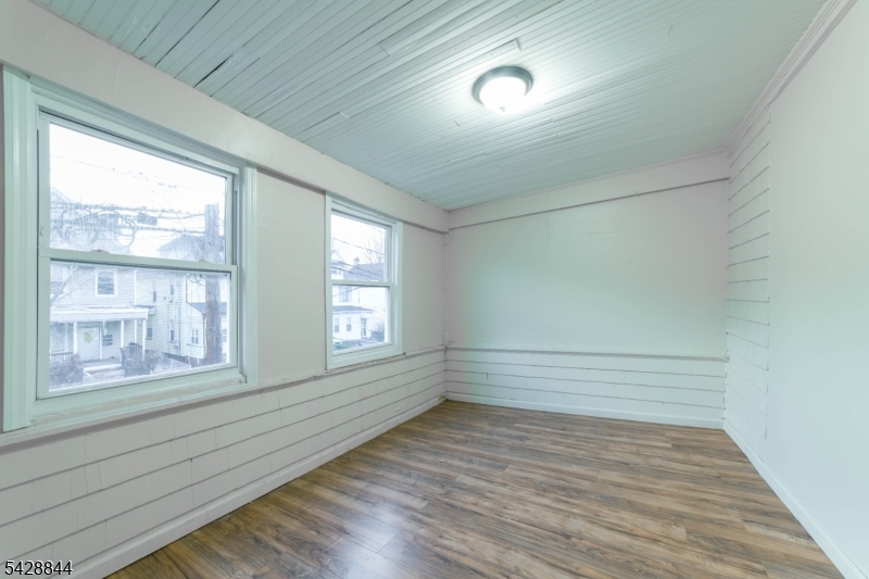 874 South 16th Street Newark, NJ 07108 - Photo 13 of 22 a view of an empty room with wooden floor and a window