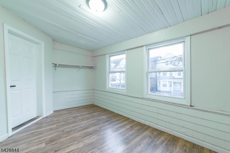 874 South 16th Street Newark, NJ 07108 - Photo 14 of 22 a view of empty room with wooden floor and fan